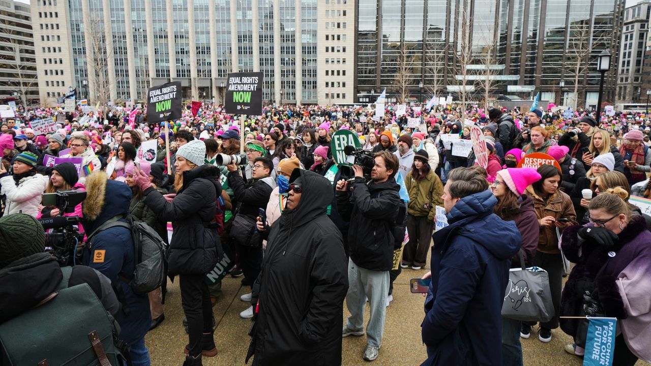 Thousands march in Washington DC as Trump heads back to capital for inauguration